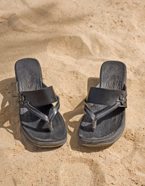 Pair of sandals on the beach Stock Image