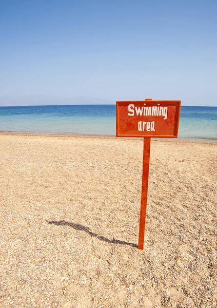 View from a tropical beach with swimming sign — Stock Photo, Image