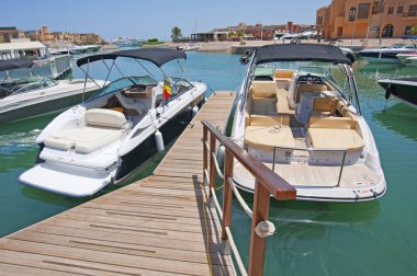 Private motor yachts moored to a jetty