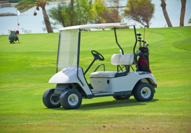 Golf buggy on a fairway clipart