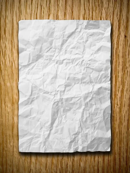 Witte verfrommeld papier op rood eiken hout — Stockfoto