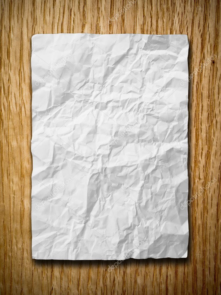 White crumpled paper on red oak wood