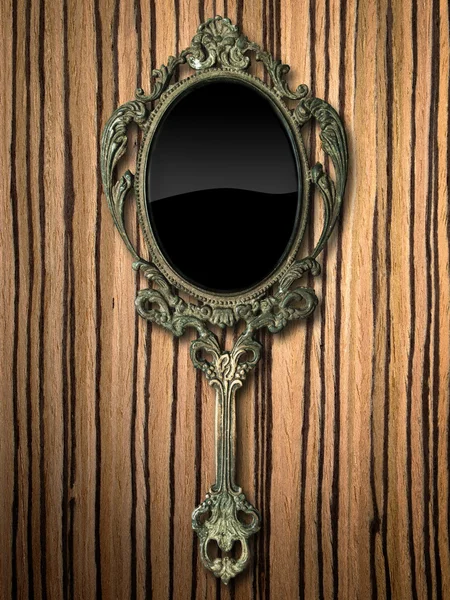 Oude hand spiegel op zebrano hout — Stockfoto