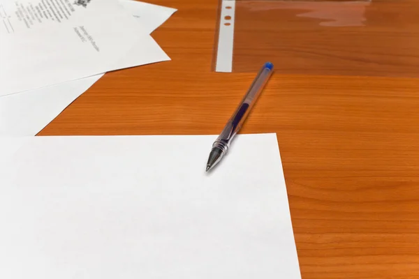 stock image Pen lying on a table, a sheet of white paper