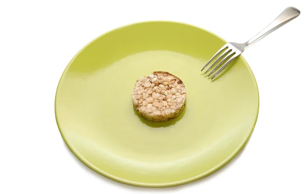 Piatto verde con pasticceria dietetica ai cereali e forchetta — Foto Stock