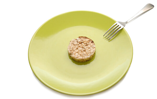 Green plate with cereal dietary pastry and fork