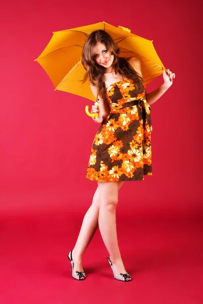 Charming girl sitting in dress with umbrella — Stock Photo, Image
