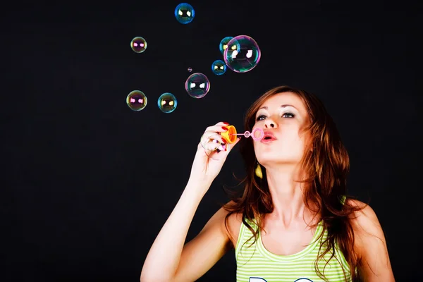 Young modest beautiful girl lets soap balls — Stock Photo, Image