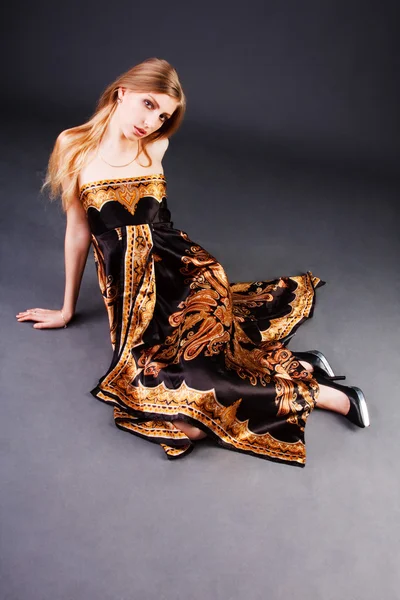 Stock image Beautiful blond girl in dress on floor