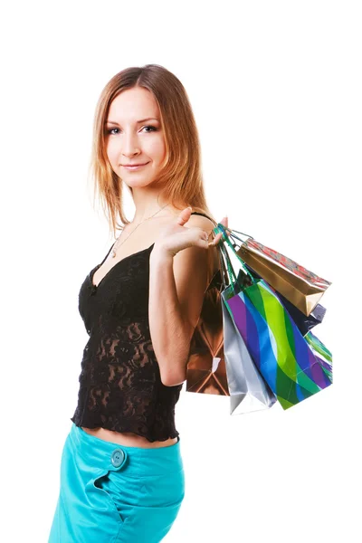 stock image Attractive young lady in blue skirt with packets