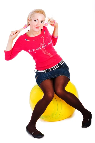Sweet young girl sits on fitness ball — Stock Photo, Image