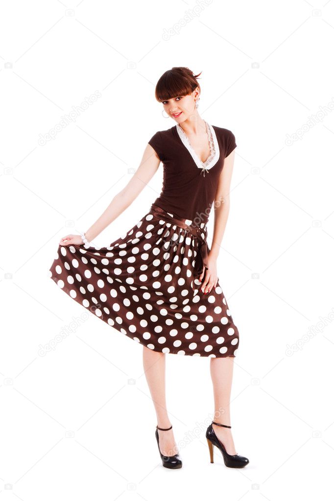 Young beautiful girl in spotted skirt