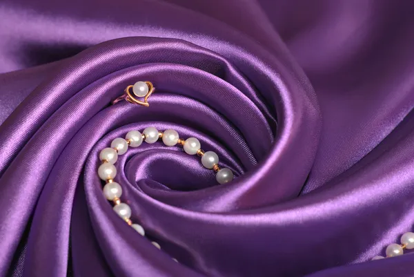 stock image Jewels on purple satin