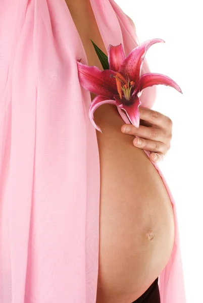Беременная женщина с цветком — стоковое фото