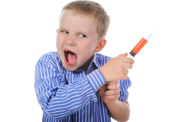 Rapaz com uma seringa na mão — Fotografia de Stock