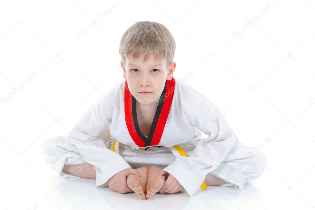 Boy in a kimono sits on a floor