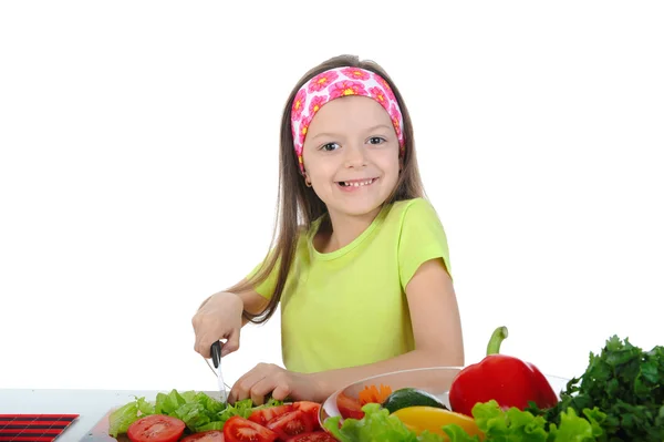 Little girl cut fresh tomatoes. — Stock Photo, Image