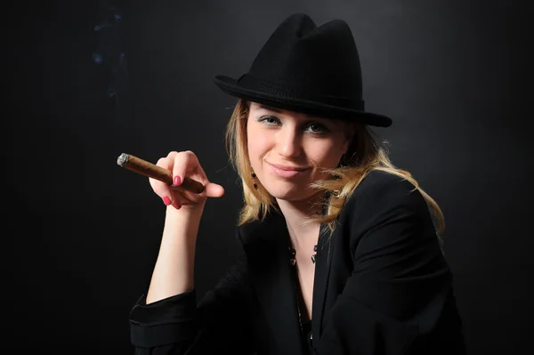 Girl in a hat with a cigar Stock Photo