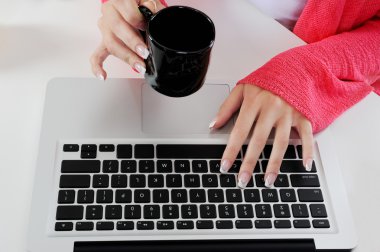 Women's hands with a manicure on the keyboard. clipart