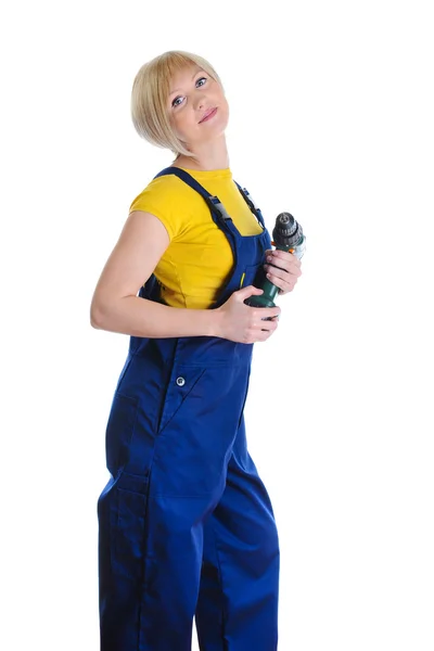 Flicka med en borr i byggnad overaller — Stockfoto
