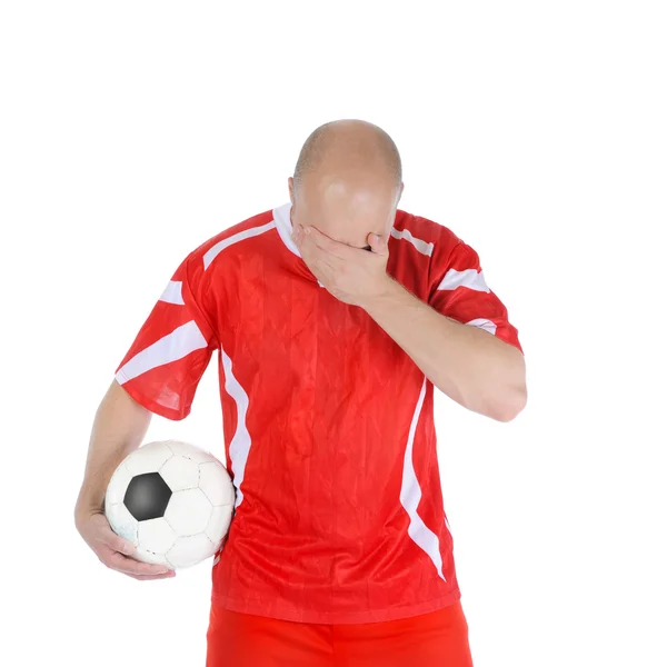 Upprörd fotbollspelare i formuläret röda. — Stockfoto