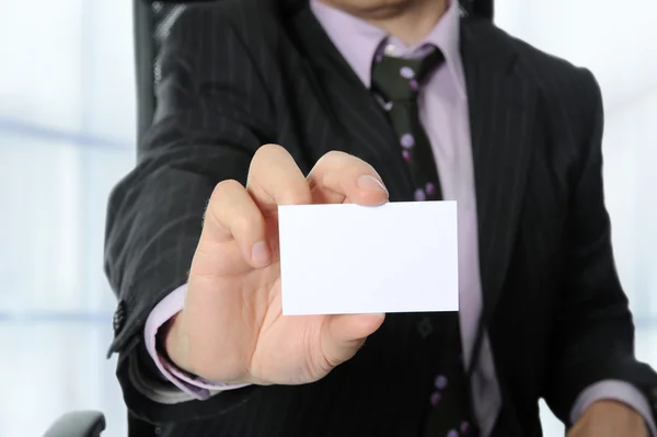 Business man handing a blank card — Stock Photo, Image