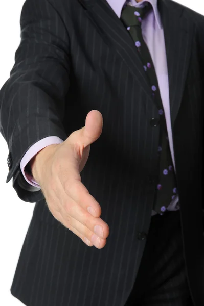 Businessman in a suit holds out his hand for a handshake. — Stock Photo, Image