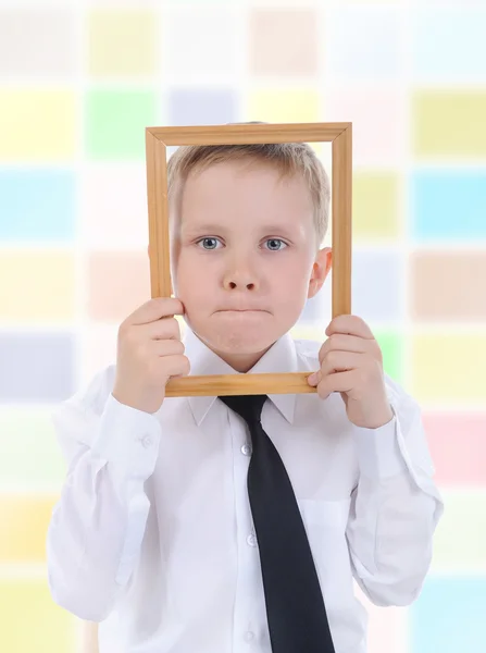Little boy with a wooden frame — Stock Photo, Image