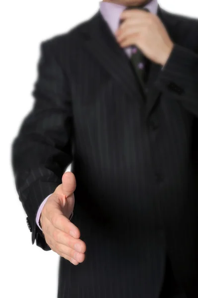 Man in a suit holds out his hand for a handshake — Stock Photo, Image
