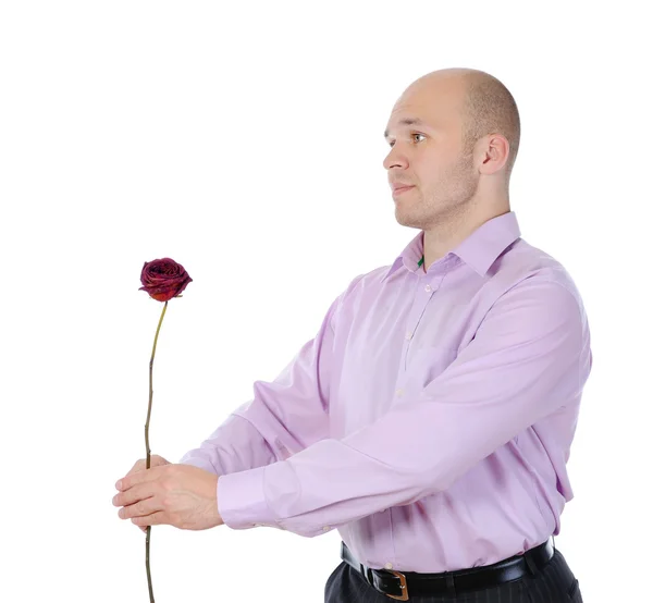 Young man with a flower in her hand. — Stock Photo, Image