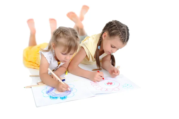 Sisters draw on the album. Royalty Free Stock Photos