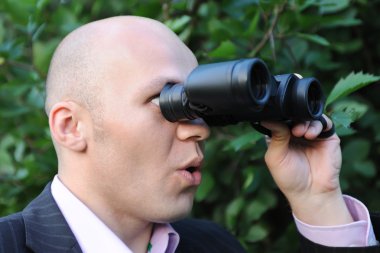 Man looking through binoculars clipart