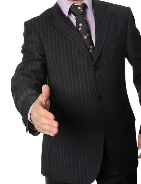 Businessman in a suit holds out his — Stock Photo, Image