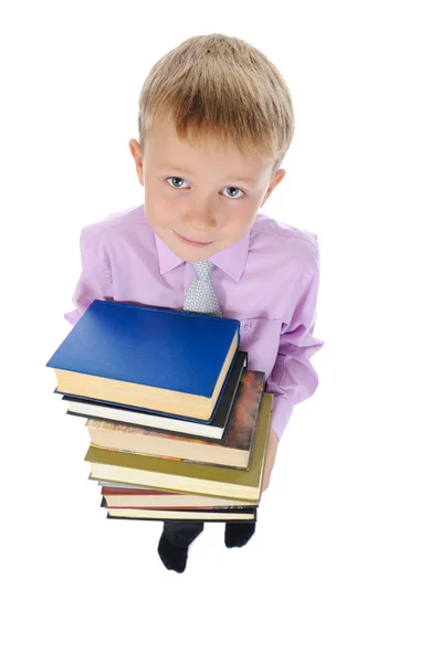Pojken håller en trave böcker — Stockfoto