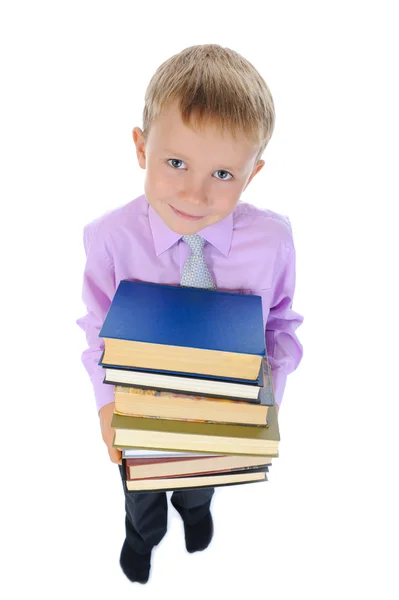 Мальчик держит стопку книг — стоковое фото