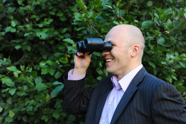 Empresário olhando através de binóculos — Fotografia de Stock