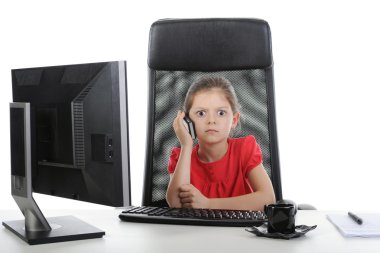 Little girl talking on the phone at the table in front of a comp clipart