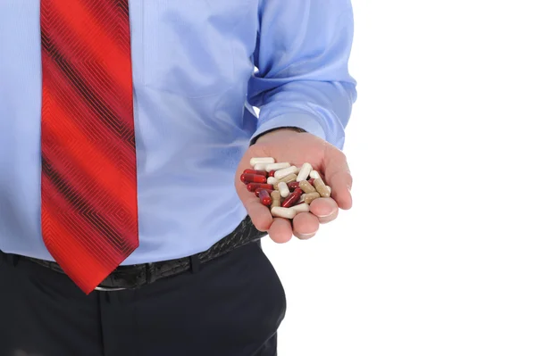 Czerwone i białe tabletki w męskie ręce — Zdjęcie stockowe