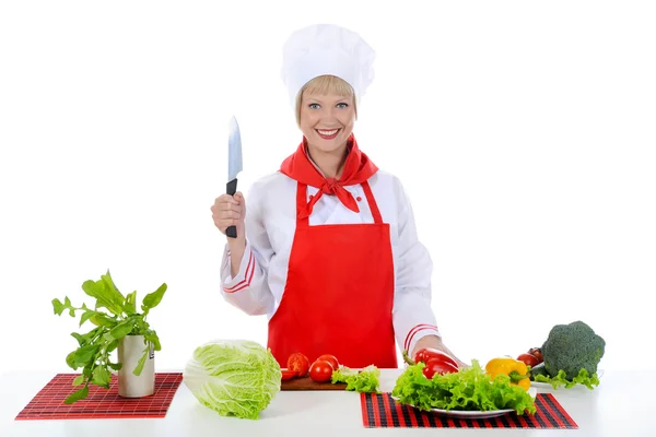 Menina loira corta os tomates na cozinha — Fotografia de Stock