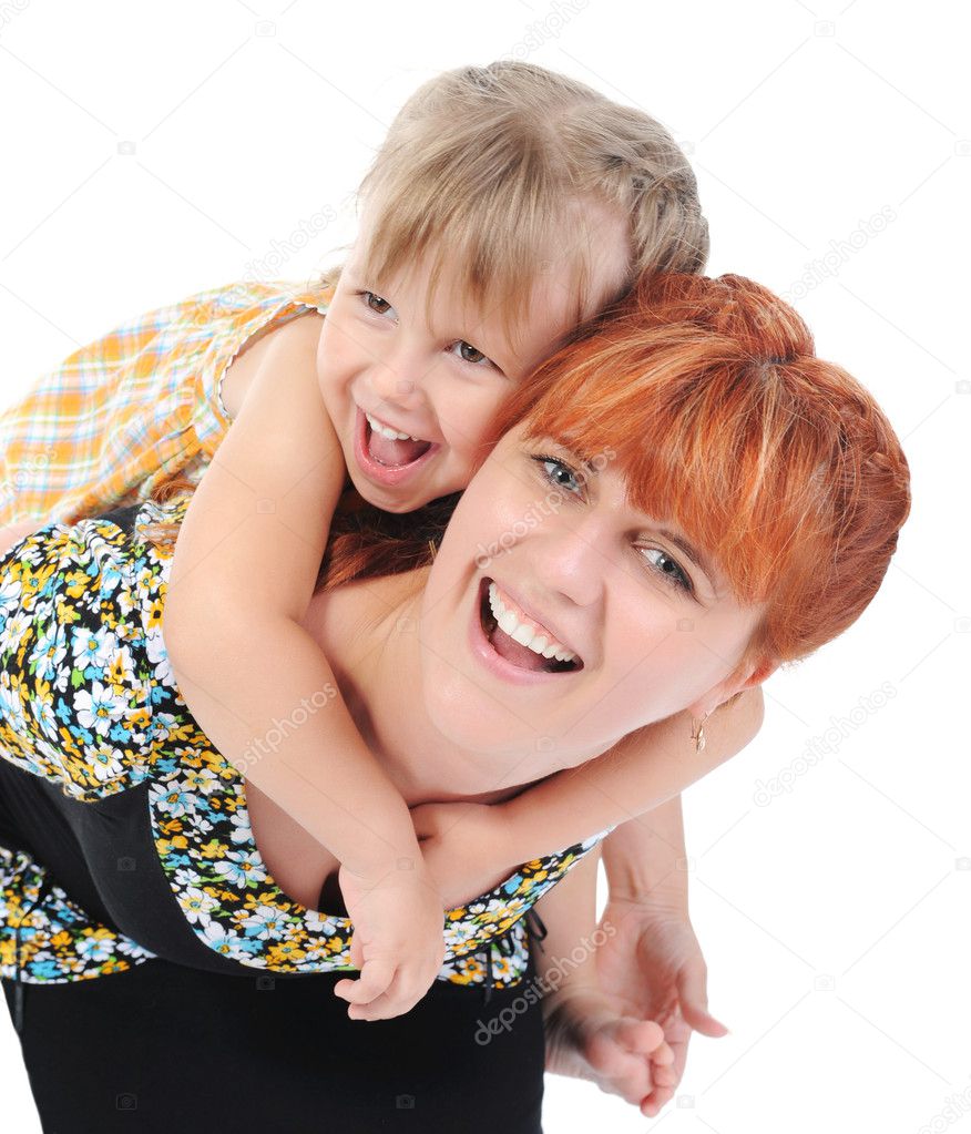 Beautiful cheerful girl hugs her young mother.