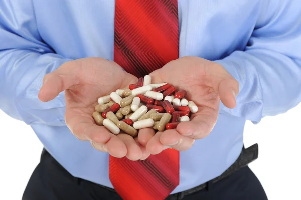 Vörös és fehér tabletta férfi kezében — Stock Fotó