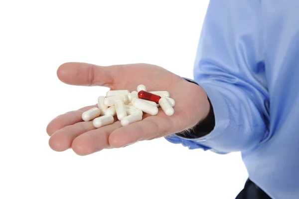 Erkek elinde kırmızı ve beyaz tabletler — Stok fotoğraf