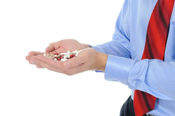 Vörös és fehér tabletta férfi kezében — Stock Fotó