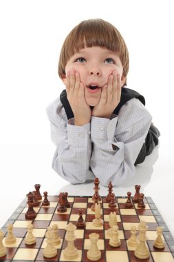 Schoolboy playing chess clipart