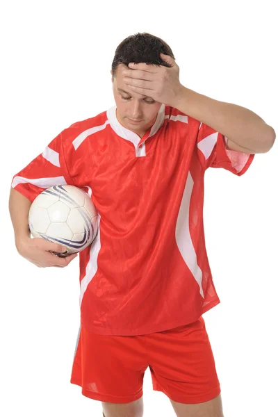 Upprörd fotbollspelare i formuläret röda. — Stockfoto