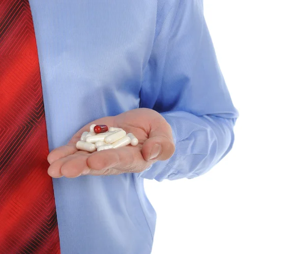 남성 손에 빨간색과 흰색 정제 — 스톡 사진