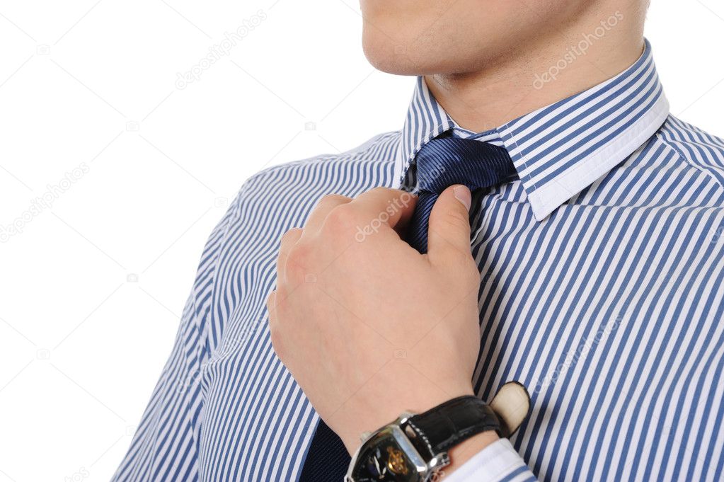 Picture of a business man adjusting his tie
