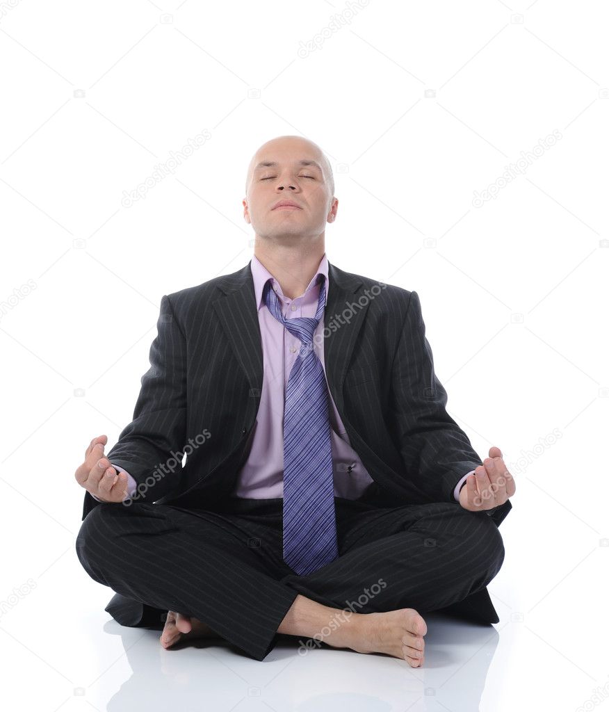 Businessman meditating in yoga lotus