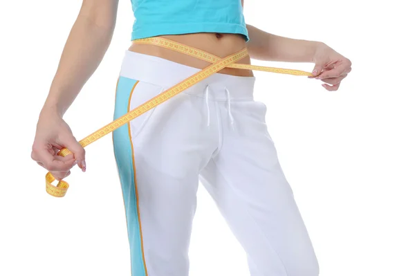 Young athletic girl measuring waist. — Stockfoto