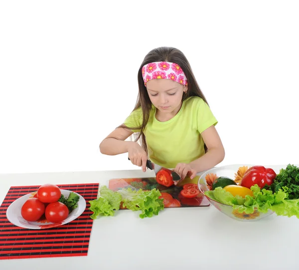 Little girl cut fresh tomatoes. — Stock Photo, Image